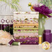A stack of the fabrics included in the Veranda collection, with flowers and a vase and a jar and a birdcage and thread.