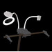 A magnifying lamp with a flexible arm and a clip base, positioned against a black background.
