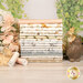 A stack of the fabrics included in the ABCs of Love with flowers and greenery and a bird statue and a bunny statue and thread.