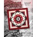 Colorful quilt design featuring a central star pattern in red, black, and white with intricate details.