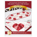 The front cover of the pattern, showing the completed Foundation Paper Piecing Hearts Table Runner, colored in red and white fabrics from the Redberry Lane collection by Henry Glass Fabrics, staged on a wooden dining table with white chairs in a bright kitchen as well as a close up detail shot.