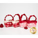 The four Tiny Treat Baskets in a neat row, staged on a white background with tossed heart décor, showing details on the fabrics and ribbon handles.