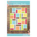 The front of the Building Blocks quilt pattern, featuring the completed quilt on a rough wood background.