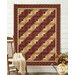 The completed Log Cabin Throw Quilt colored in rich red and deep tan fabrics from the Dear Scarlet collection by Marcus Fabrics, staged on a farmhouse porch style wall and deck with coordinating flowers and furniture.