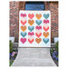 Patchwork heart quilt on a background a brick home front patio.