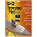 An ironing mat with packaging, featuring an iron and hand embroidered fabric.