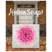 The front of Modern Scrap Quilts book featuring a quilt hanging on a front porch ornamental railing.