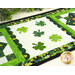 A close up on the center of the small table topper, showing off the laser cut shamrocks and scallop borders. 