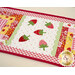 A close up on the center of the small table topper, showing off the laser cut strawberries and scallop borders. 