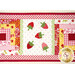 A close up on the center of the small table topper, showing off the laser cut strawberries and scallop borders. 