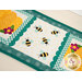A close up on the center of the small table topper, showing off the laser cut bumble bees and scallop borders. 