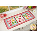 The completed Sew Cute Runner - September table topper, staged on a white dresser, accented with scattered apples and a daisy.