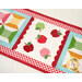 A close up on the center of the small table topper, showing off the laser cut apples and scallop borders. 