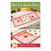 The front of the Sew Cute runner - June pattern showing the completed runner staged on a dresser with coordinating décor. 