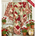 The completed Easy as ABC and 123 quilt kit - Ambiance, draped over a white porch surrounded by red geraniums. 