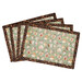 A shot of the four completed overlapping placemats made with coffee-themed taupe fabric with printed text and coffee bean fabric borders, isolated on a white background.