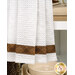 A close up of the bottom of the hanging towel, showing a decorative strip of brown plaid fabric and the white towel fabric. 