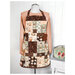 An example of the Simply Charming Apron, completed in coffee themed fabrics and paired with a light pink shirt.
