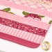 Close-up of a quilted drying mat with pink and floral patterns, showcasing a variety of textures and shades.