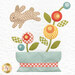 A close up shot of a quilt block featuring a rabbit jumping over potted flowers. 