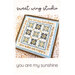 The front of the You Are My Sunshine cross stitch pattern, framing a geometric quilt block design.