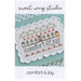 The front of the Comfort & Joy cross stitch pattern, showing the completed project with coordinating décor.