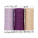 Three spools of lilac, purple, and cream thread, isolated on a white background. 