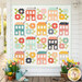 The completed Spring Town Quilt colored in vibrant fabrics from the Delightfully Yours collection by Moda Fabrics, hung on a white paneled wall on a porch with coordinating flowers and garden items.