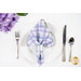 A shot of one of the napkins with the plaid faced out, staged on a white plate with a brushed nickel napkin ring.
