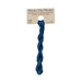 A skein of navy blue embroidery floss, twisted and bundled, with a tan label featuring the brand name and color information.