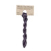A skein of variegated, muted purple embroidery floss, twisted and bundled, with a tan label featuring the brand name and color information.