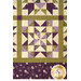 A close up on the patchwork of the quilt, demonstrating details on the fabrics, piecing, and top quilting.