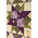 A super close up on one of the patchwork blocks, demonstrating details on the fabrics, piecing, and top quilting.