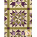 A close up on the patchwork of the quilt, demonstrating details on the fabrics, piecing, and top quilting.