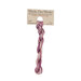 A skein of variegated magenta and light pink embroidery floss, twisted and bundled, with a tan label featuring the brand name and color information.