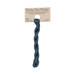 A skein of deep teal embroidery floss, twisted and bundled, with a tan label featuring the brand name and color information.