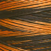 A variegated orange and black swatch of Weeks Dye Works floss.
