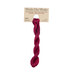 A skein of ruby red embroidery floss, twisted and bundled, with a tan label featuring the brand name and color information.?