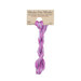 A skein of variegated magenta and purple embroidery floss, twisted and bundled, with a tan label featuring the brand name and color information.