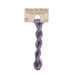 A skein of muted violet embroidery floss, twisted and bundled, with a tan label featuring the brand name and color information.