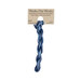 A skein of dark and denim blue embroidery floss, twisted and bundled, with a tan label featuring the brand name and color information.