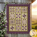 The completed Patchwork BOM quilt, colored in beautiful beige, green, and plum purple fabrics from the Collection for a Cause: Essence collection by Moda Fabrics, staged on a rustic gray barn wall at sunset.