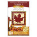 Front cover of the pattern showing the completed Foundation Paper Piecing Series 4 November project, a maple leaf in warm rust red, mahogany, and cream prints, displayed on a craft hanger and staged with coordinating foliage.