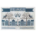 A stitched sampler featuring blue houses, snowflakes, and the word PEACE surrounded by alphabet letters.