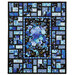 The completed Stained Glass Panel Quilt colored in the bright blue fabrics of the Escapade collection, with a stunning floral panel at the center, contrasted with striking black borders, isolated on a white background.