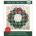 Front of the pattern with an image of the completed Haul Out the Holly quilt isolated on a white background with green banners at the top and bottom with the title of the product and creator information