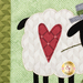 A super close up on the appliqué heart detail on the sheep, demonstrating fabric colors and stitching on the project.