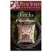 Front of pattern showing the completed cross stitch design finished as a pillow on a decorative plate with greenery.