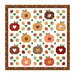 Image of the Cozy Autumn quilt featuring patchwork pumpkins, falling leaves, and hearts.