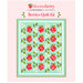 A digital mock-up of the completed Berries Quilt kit, colored in the Bloomsberry collection by Moda, set on a pink background with the collection logo at the top.